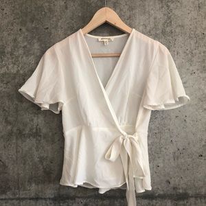 Cream colored, wrap, v-neck, peplum blouse